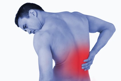 Back view of male suffering from back pain against a white background